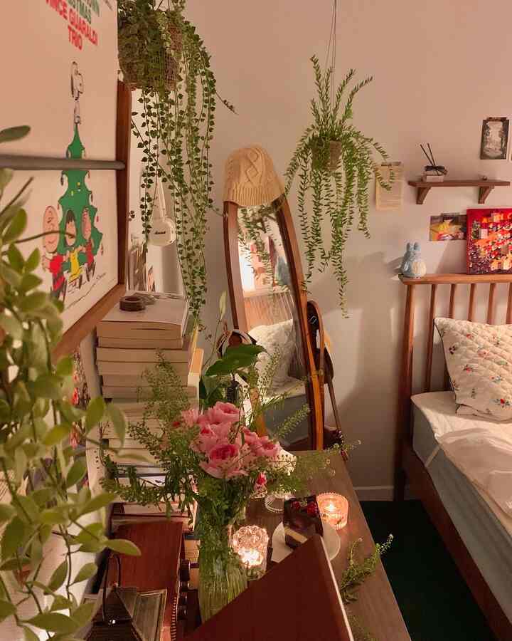 A warm wood-toned vintage bedroom featuring plants and candles, creating a cozy and comfortable atmosphere