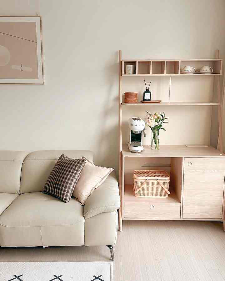 White walls and wood tone furniture with natural materials and sofa arranged in a modern home cafe space
