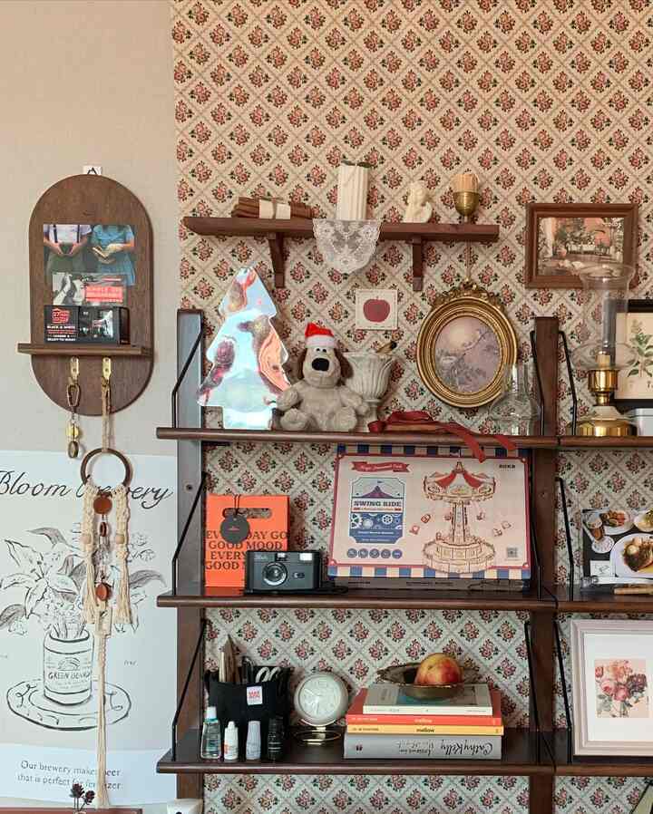 Beige and brown toned wall shelves featuring vintage decor items in a charming wall decoration space
