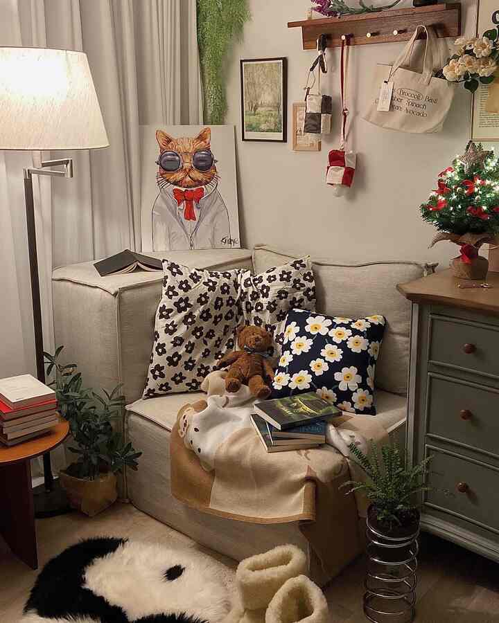 Warm ivory and beige tone bedroom corner featuring a sofa with cushions and blanket creating a cozy atmosphere