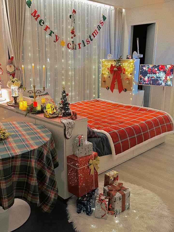 White and red toned bedroom featuring Christmas decorations, blankets, rug, and gifts creating a cozy and warm winter atmosphere
