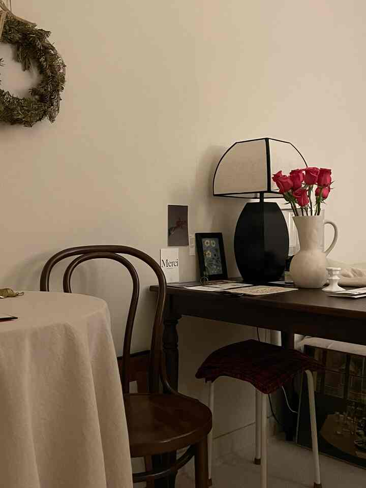 Bright ivory walls with wooden table and chair arranged in a warm, natural-feeling living room