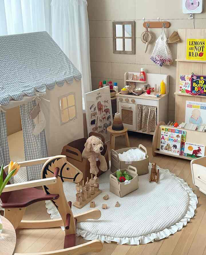 Beige wood-toned kids' room featuring wooden toys and a cozy baby tent in a charming arrangement