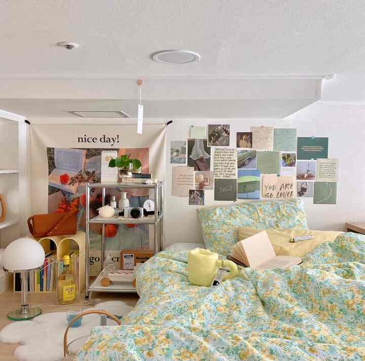 White and wood tone loft bedroom featuring floral bedding, floor lamp, and side table with cozy, colorful atmosphere
