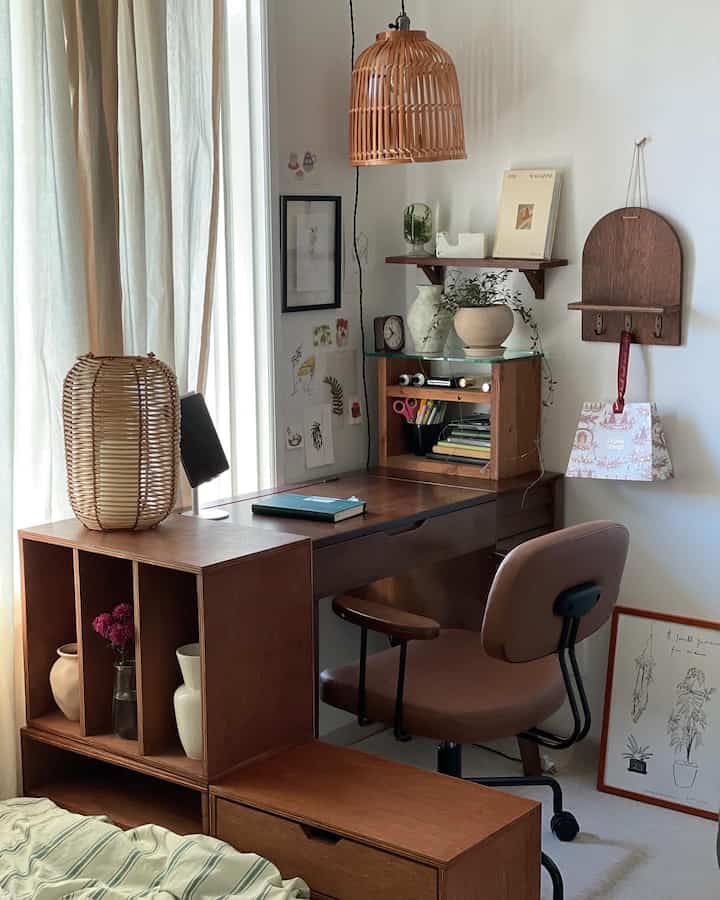 Natural-toned curtains and wooden desk with chair arranged in a cozy home office space