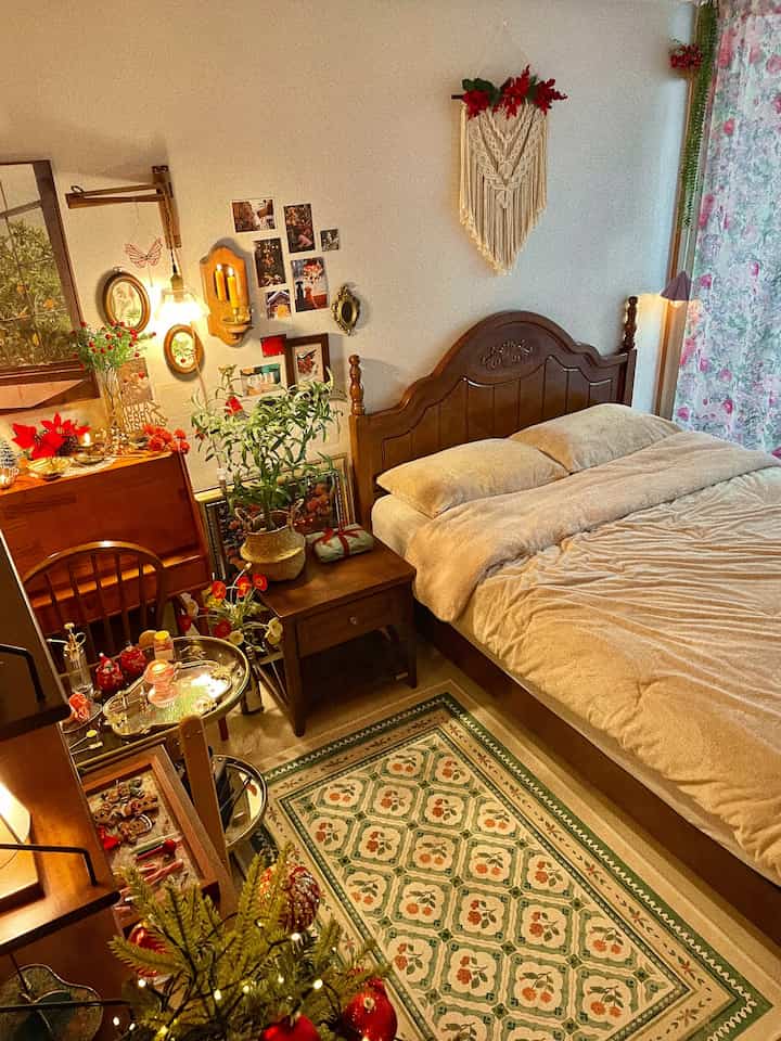 Warm wood tone vintage bedroom featuring floral rug, wooden furniture, and cozy wall lighting creating a nostalgic atmosphere