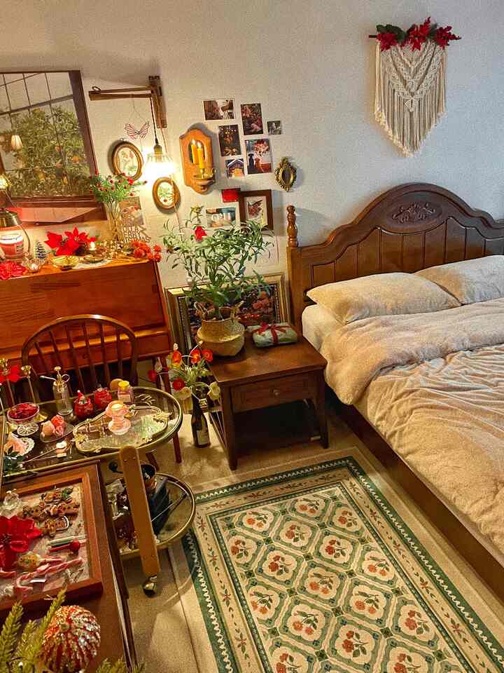A bedroom in brown and natural tones featuring vintage-style furniture, plants, picture frames, and a patterned rug creating a cozy atmosphere