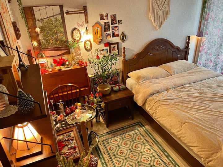 Warm brown-toned bedroom featuring classic wooden bed and wall decor with a cozy atmosphere