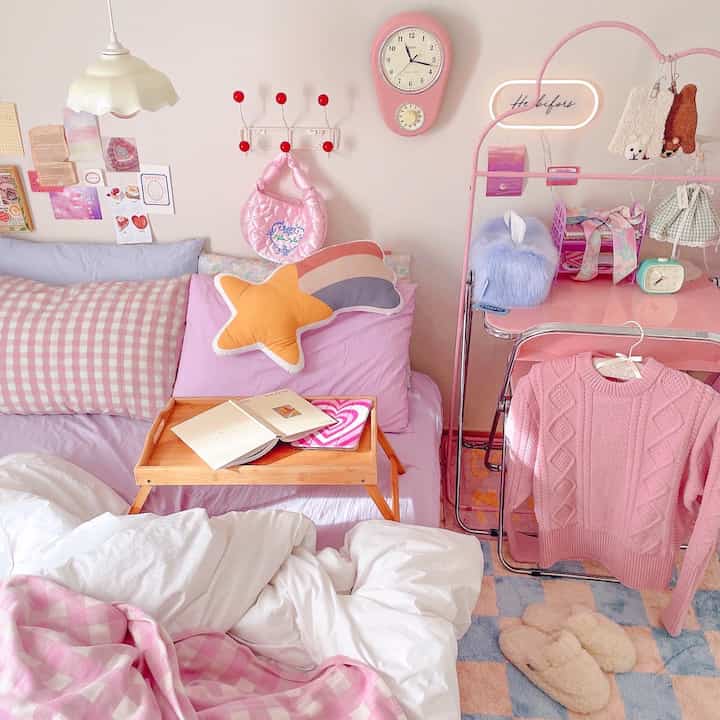 Pink-toned bedroom featuring bed with checkered duvet cover and cozy feminine decor