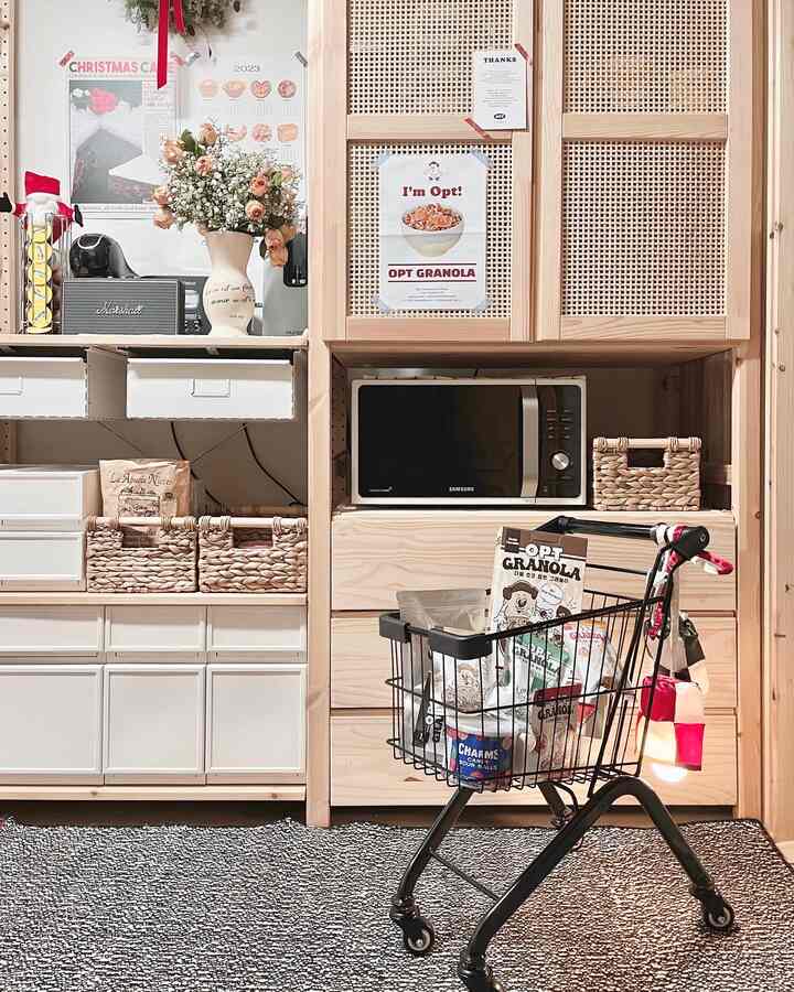 Natural wood shelves in a neatly organized pantry space with a black shopping cart and gray rug creating a warm kitchen storage atmosphere