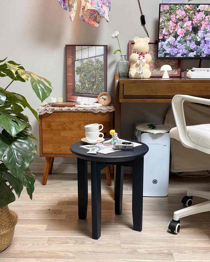 Natural brown wood furniture and black stool in a cozy home office space