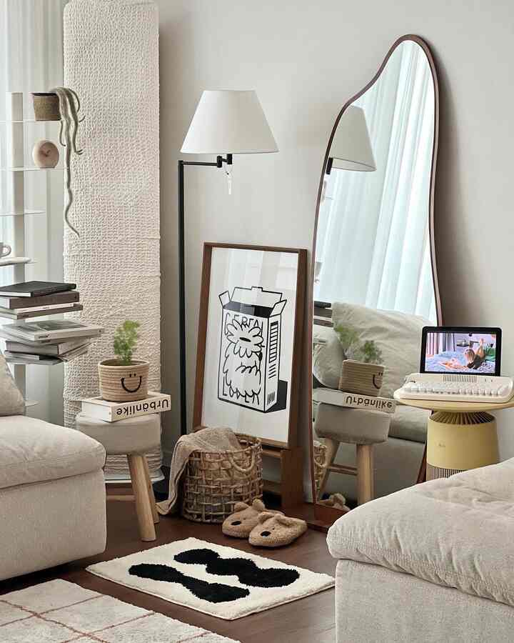 Natural-toned living room featuring cream sofa, wooden stools, baskets, and rugs with cozy atmosphere
