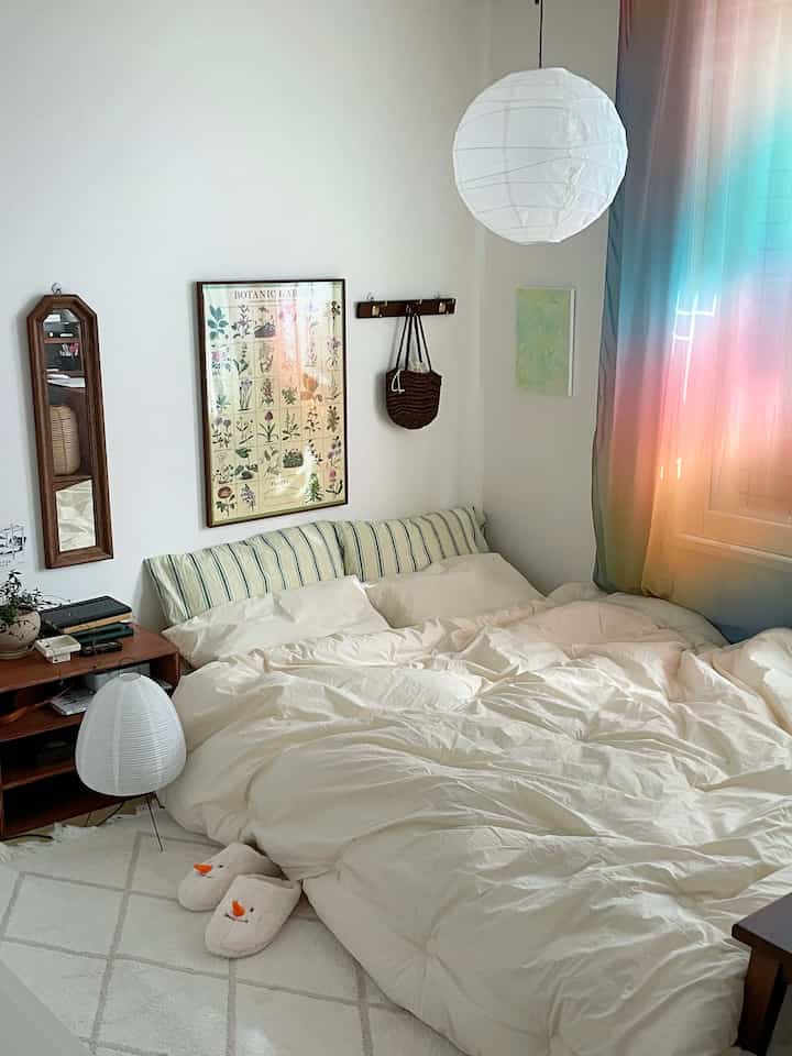 Natural toned bedroom featuring wood accents, gradient curtain, and hotel-like bedding set creating a cozy atmosphere.