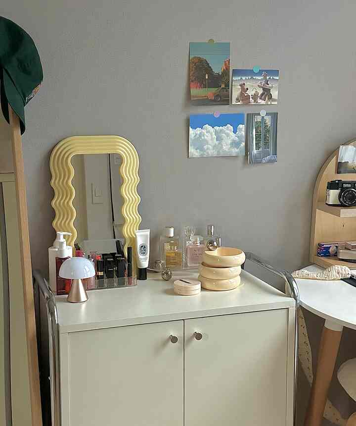 Minimal space featuring white vanity with mirror and natural wood tones blending with soft curved design elements