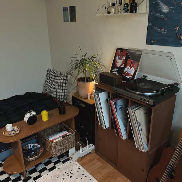 Cozy living room with natural brown wood tone furniture and vintage record player setup