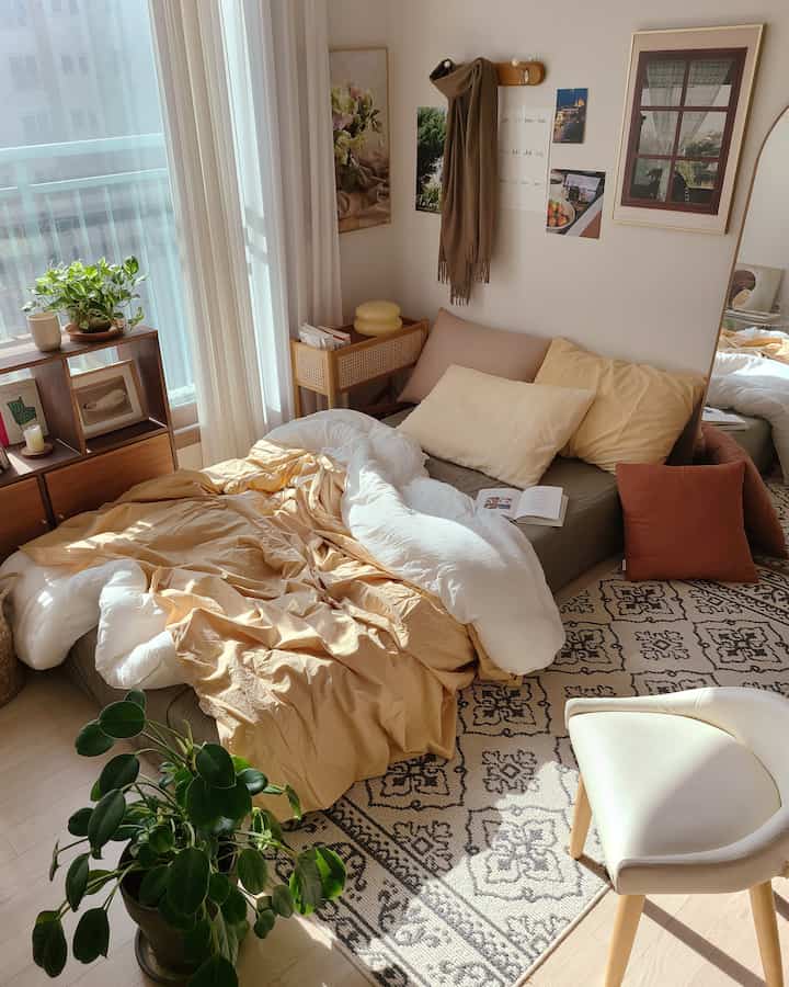 Warm beige and white-toned master bedroom featuring sunlit bed, indoor plants, and a cozy natural modern style atmosphere