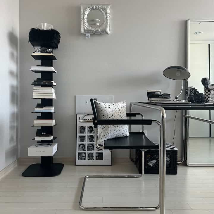 Modern and simple home office space in black and white tones, featuring chrome desk and chair with minimalist design