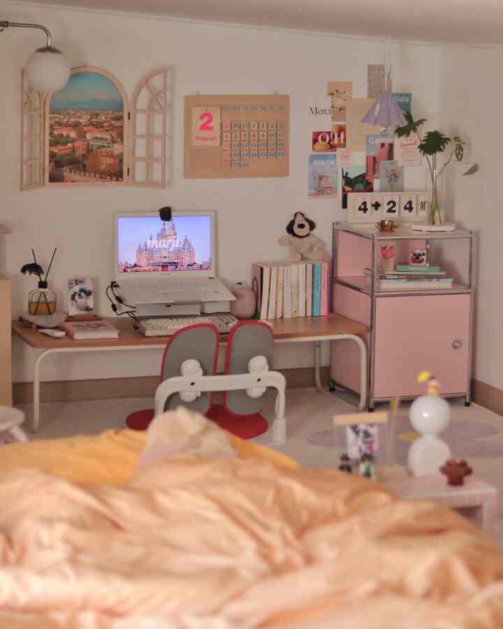 Natural tones and pink accents decorate a loft home office with desk, calendar and wall decor creating a cozy atmosphere