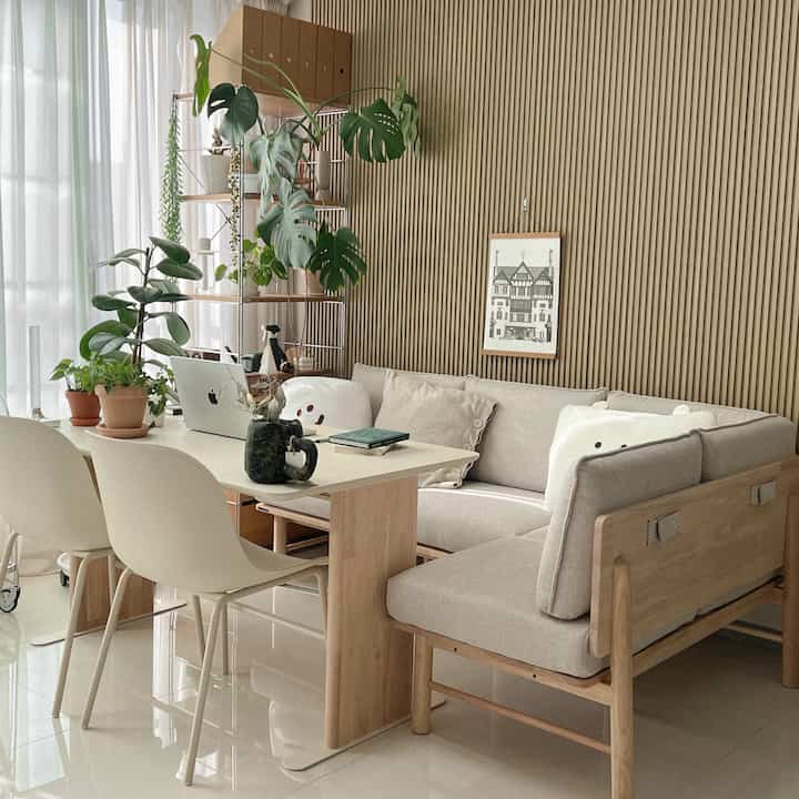 A natural wood tone and modern styled living room featuring dining table and sofa creating a cozy atmosphere