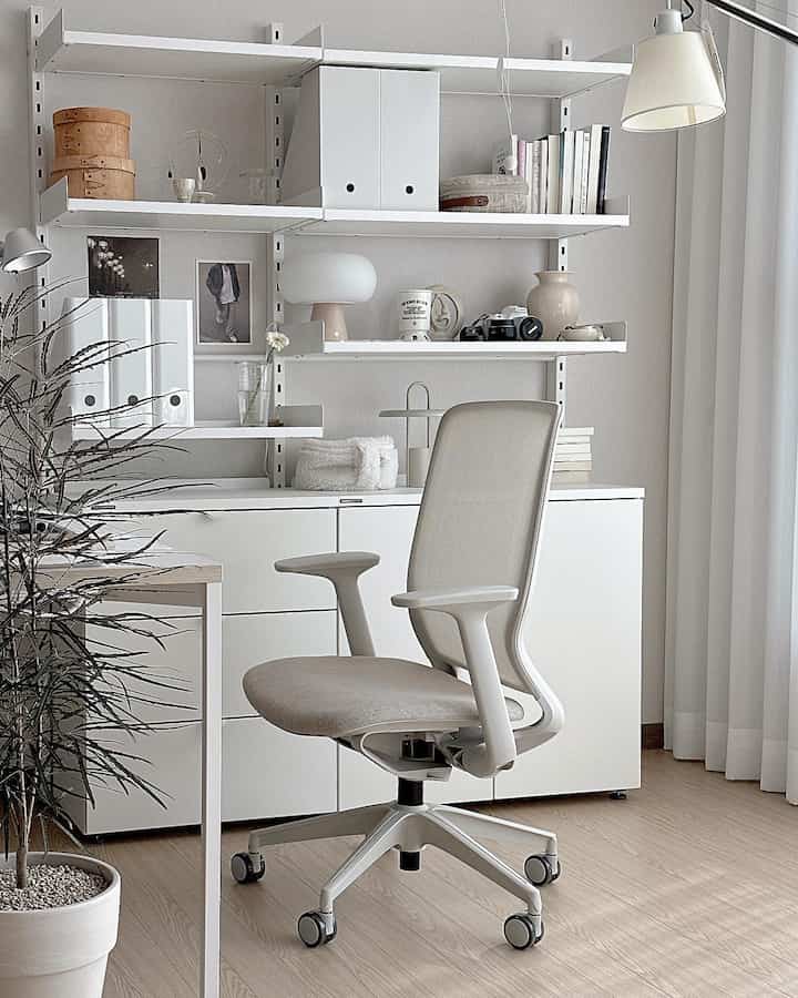 Beige and white toned home office space featuring Hanssem shelves and comfortable desk chair with modern design