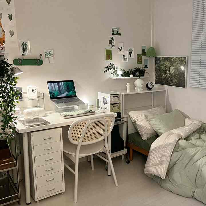 Natural-toned single household small bedroom featuring white desk, rattan chair, and single bed creating a cozy home office space