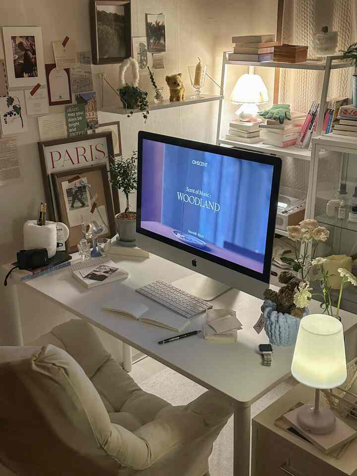 White and beige toned home office featuring desk, monitor, and comfortable chair creating a neat workspace