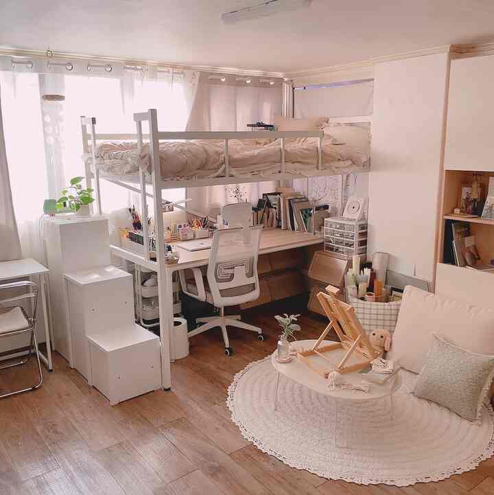 White and beige toned bedroom featuring a loft bed and workspace with a cozy natural interior atmosphere