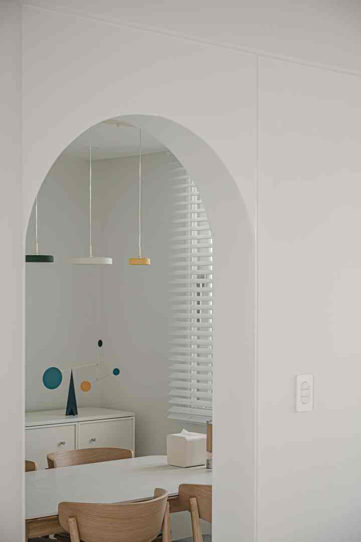 White and wood tone dining room with simple modern dining table and chairs creating a cozy atmosphere