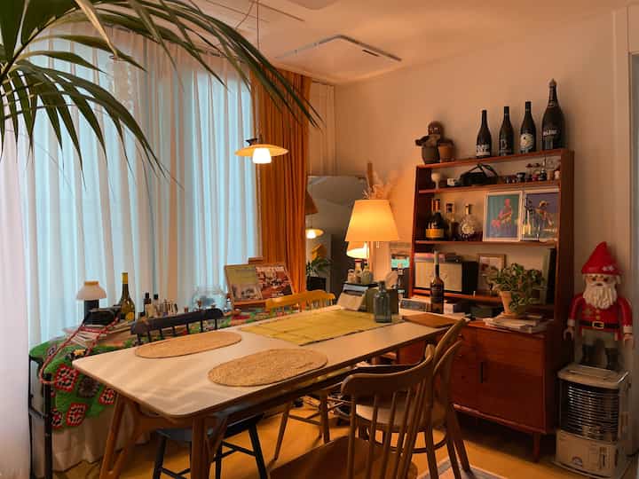 Cozy dining room in warm wood tones and orange hues, featuring a dining table and chairs