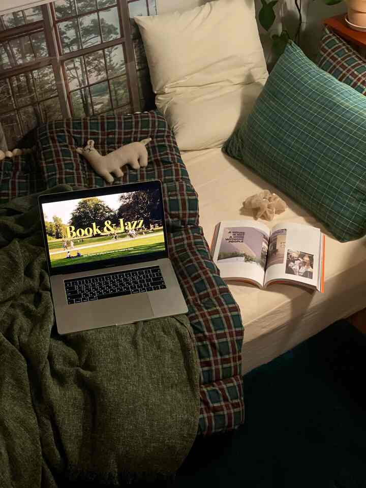 White and green toned bedroom space featuring bed and sofa, cozy Nordic style interior