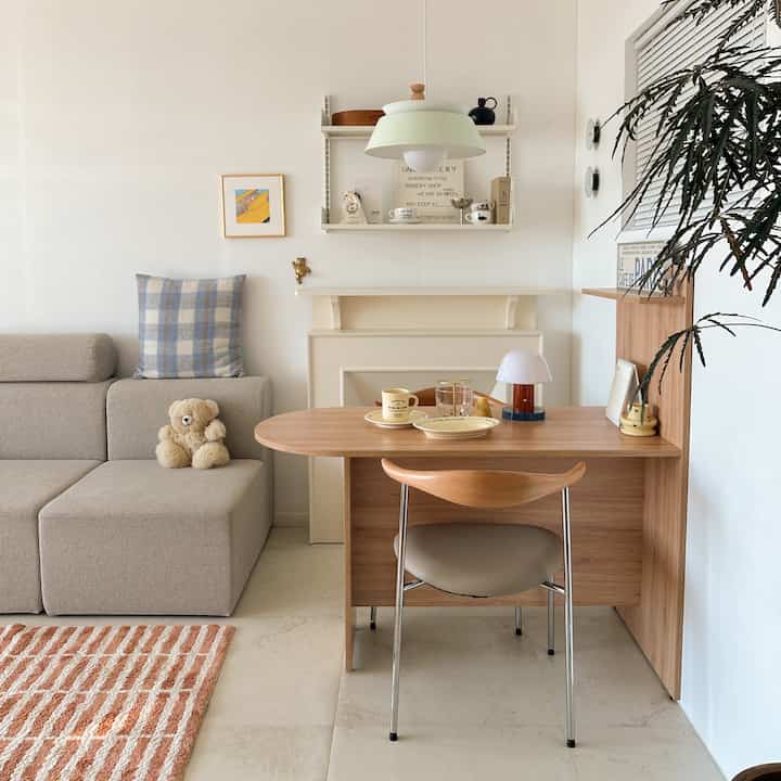 Beige and wood tone living room featuring dining table and sofa with natural modern style interior