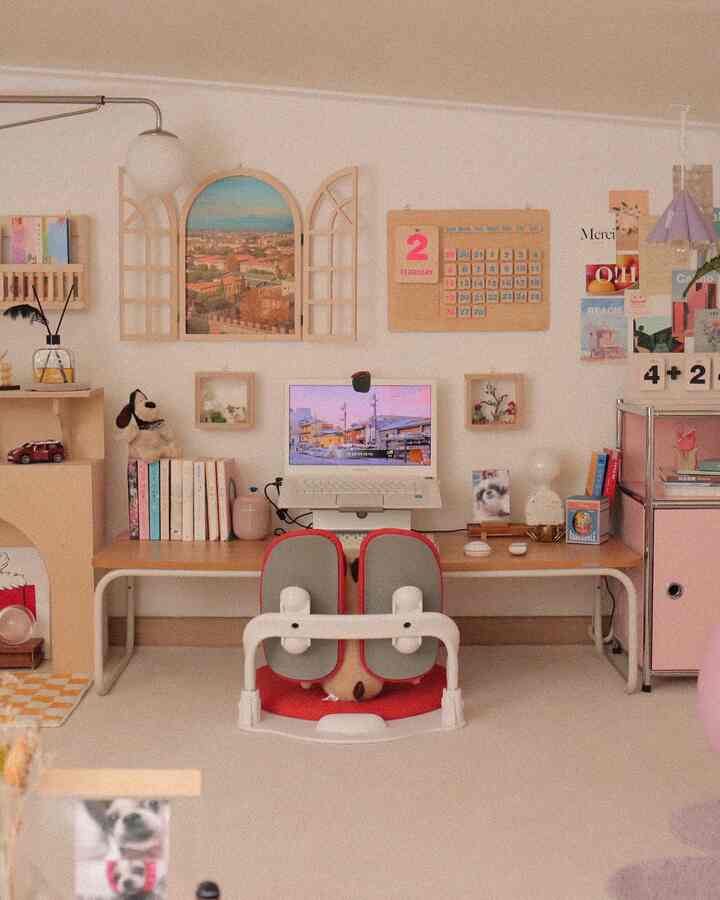 Bright beige and soft pink toned home office space featuring a desk with computer and dog-themed decor, creating a cozy work area