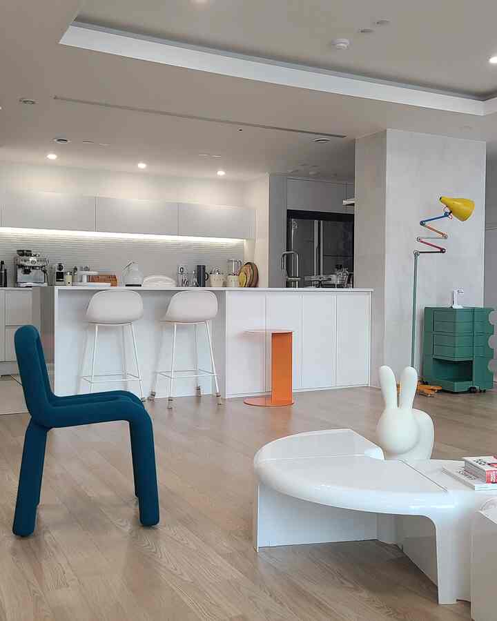 White and wood tone open kitchen facing the living area, featuring modern and minimal atmosphere