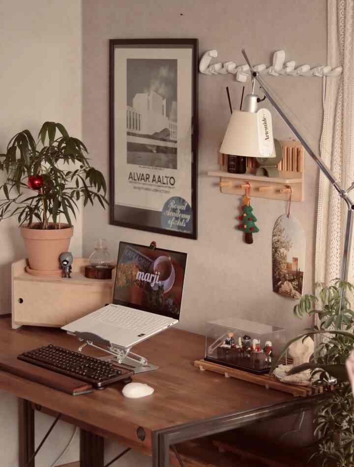 Beige and wood tone home office space featuring a desk and plants with cozy work atmosphere