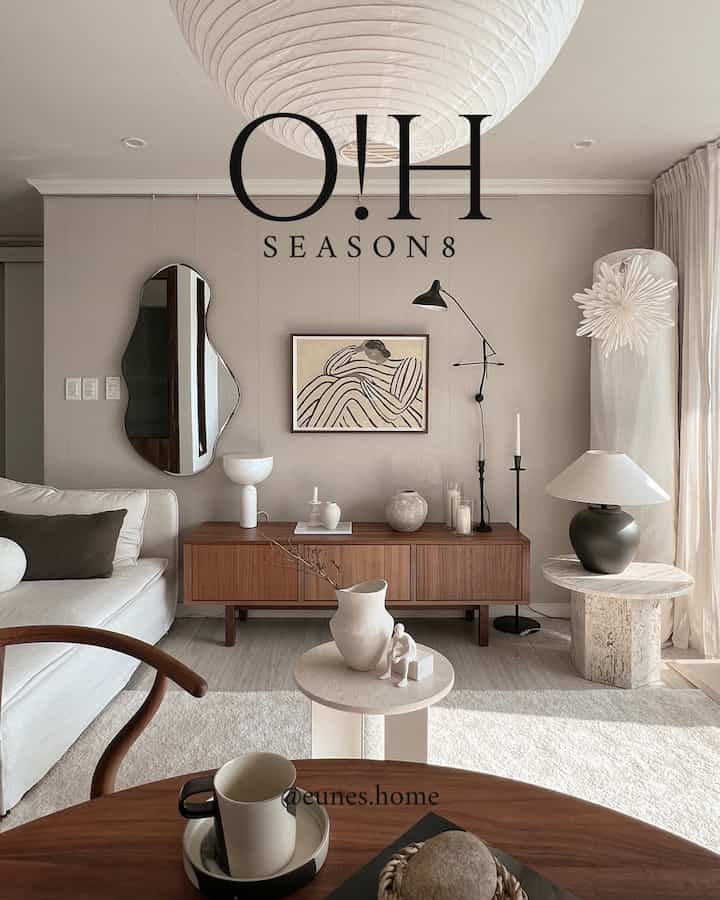 A living room with a harmonious blend of white and wood tones, featuring wooden furniture and minimalistic objets for a warm, simple atmosphere