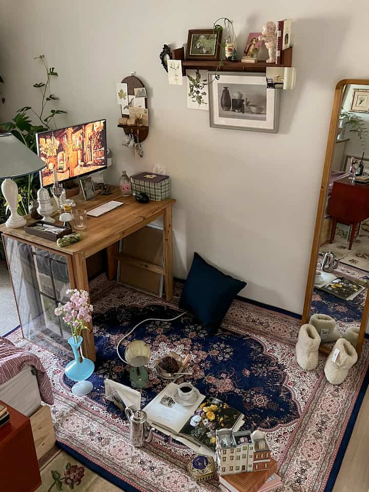 Natural home office and game room featuring a navy Persian carpet and wooden desk with cozy decor