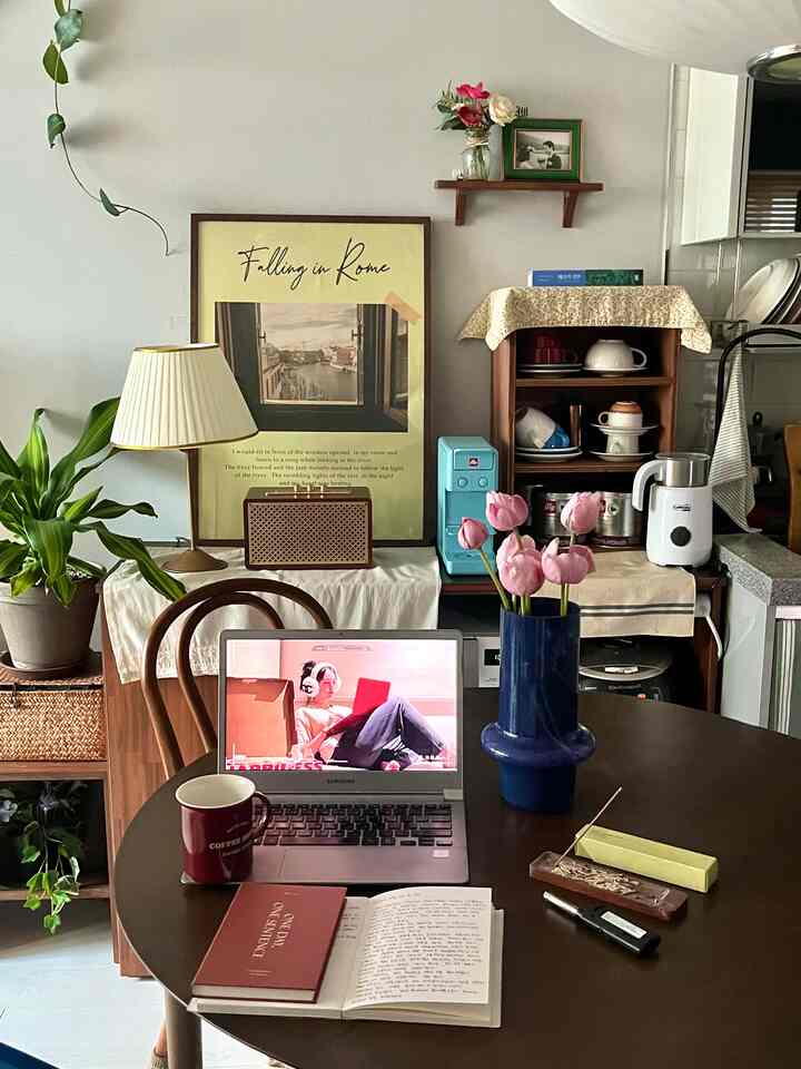 Natural-toned kitchen and dining area featuring vase, poster, and a cozy home cafe atmosphere
