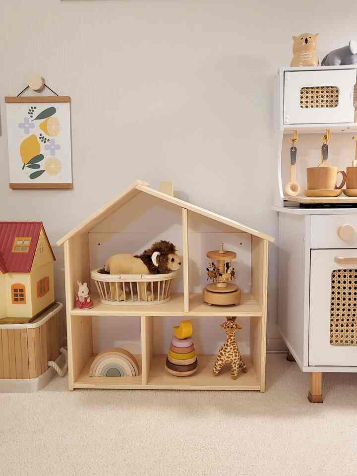 Natural toned kids' room featuring wooden dollhouse and toys in a cozy setting