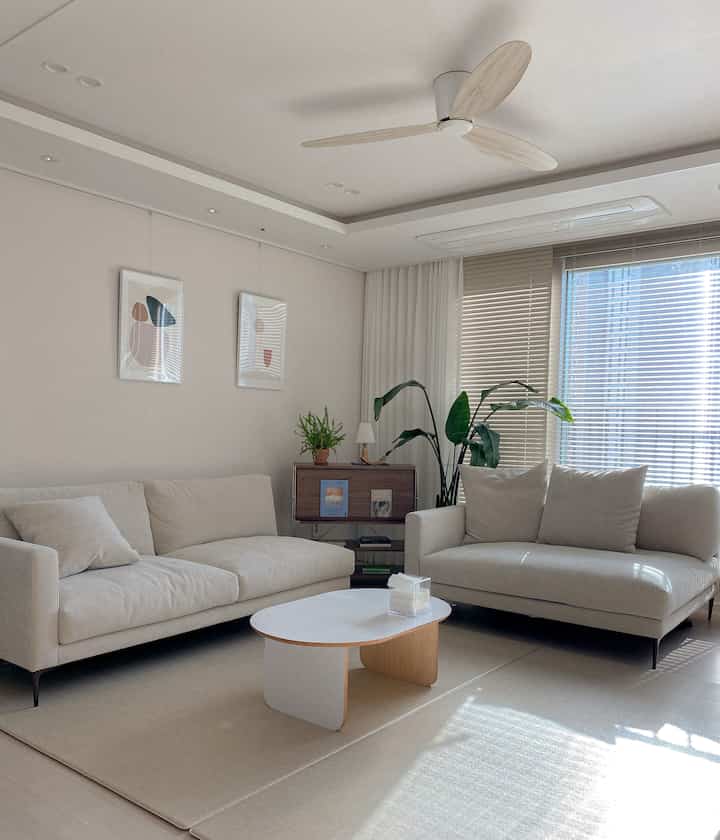 Calm beige-toned living room featuring two fabric sofas and a coffee table in a natural modern style space