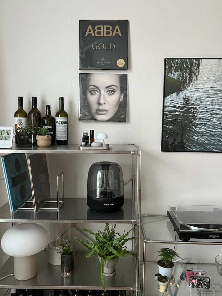 White-walled space with metal shelving, vinyl records, and audio equipment arranged, creating a modern vibe