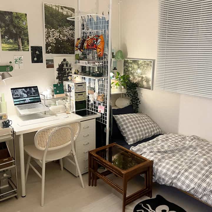 White-toned bedroom featuring a desk and chair creating a cozy, compact home office space
