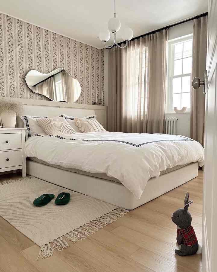 Natural tones beige bedroom with white bed and beige curtains, creating a cozy and calm atmosphere