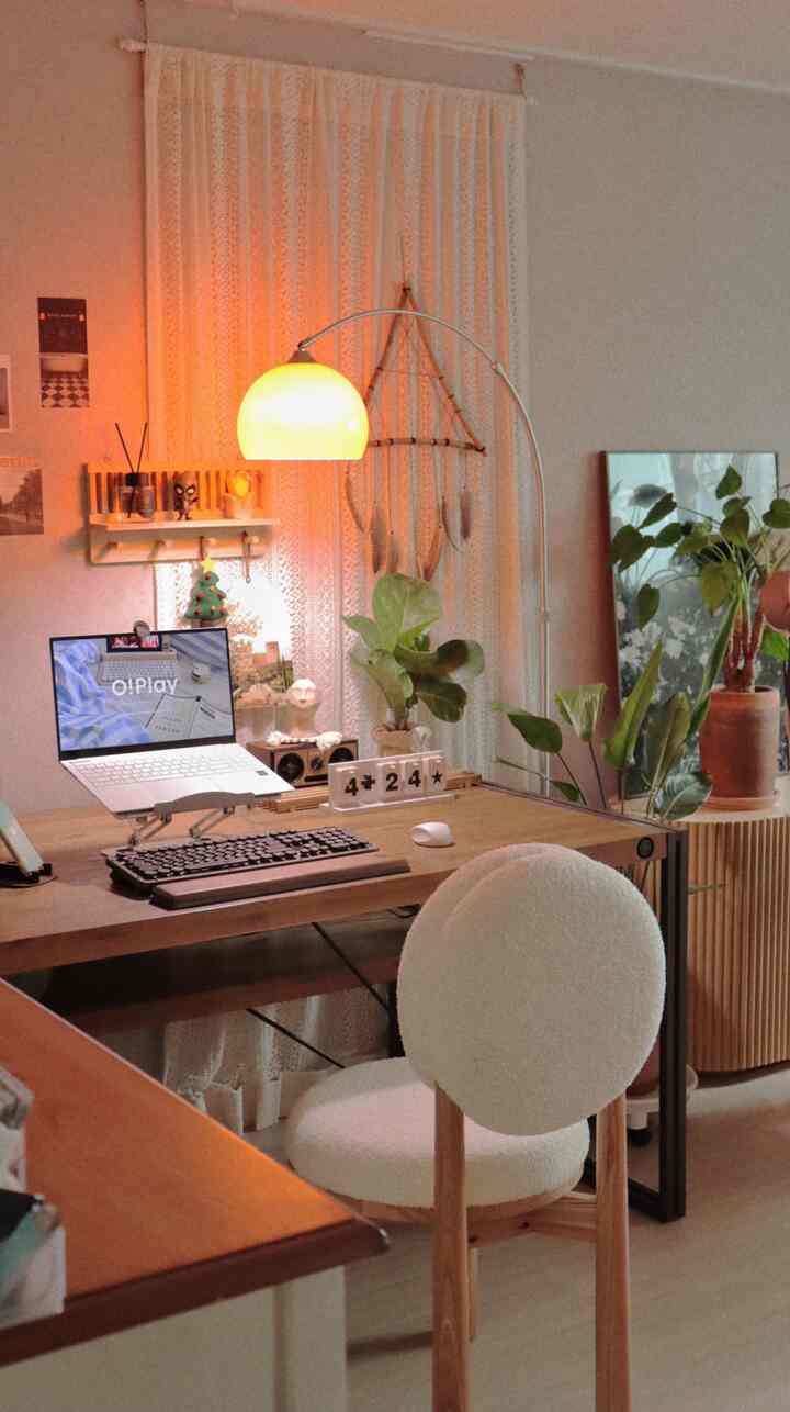 Ivory and wood-toned home office featuring a desk with laptop and keyboard, creating a cozy, natural atmosphere