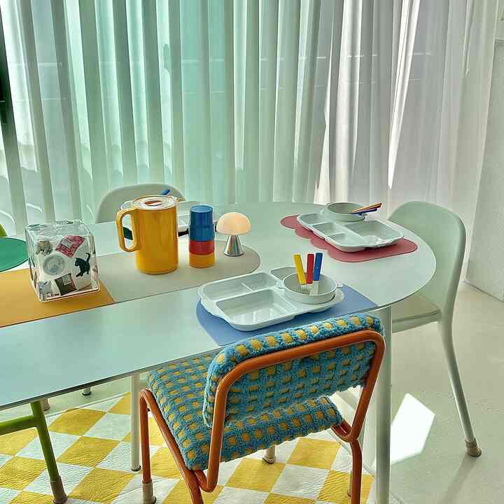 Bright and natural dining space featuring yellow and pastel-tone table and chairs