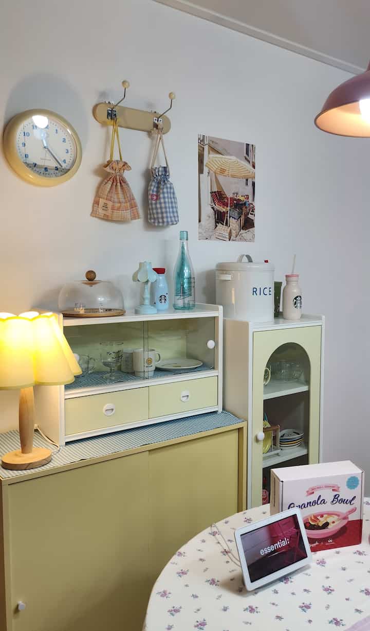 Yellow-toned kitchen corner featuring mini cabinet and sliding storage with a fresh and minimal atmosphere