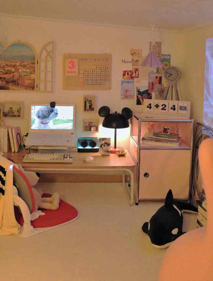 Bright white and wood-toned home office featuring a desk with computer and cute dog-themed decor creating a cozy workspace