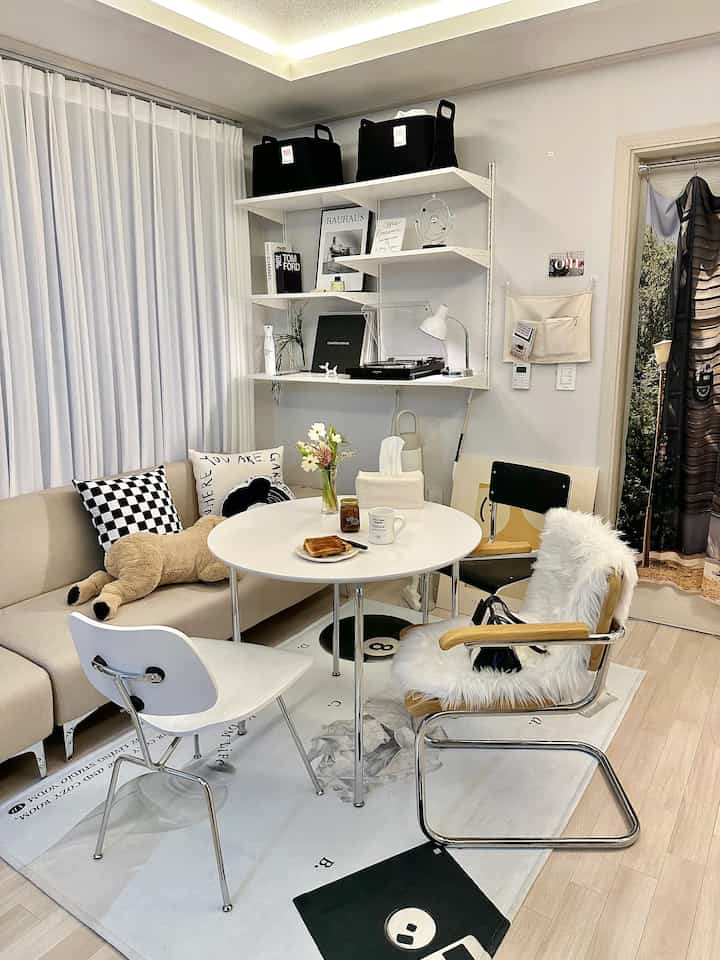 White and beige toned living room featuring a round table and Mid-Century Modern furniture with a cozy atmosphere