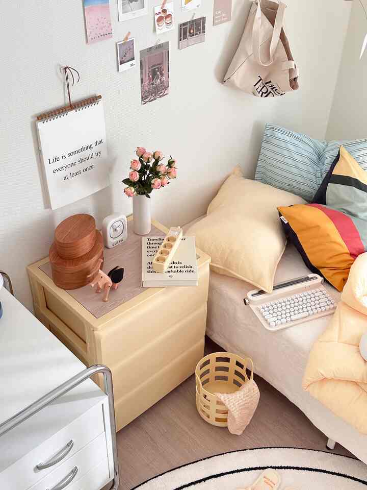 Butter yellow toned small bedroom featuring a yellow dresser and beige bedding creating a cozy atmosphere
