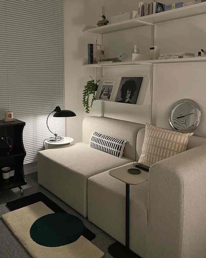 Natural tone study featuring beige sofa and black table lamp with modern mood lighting