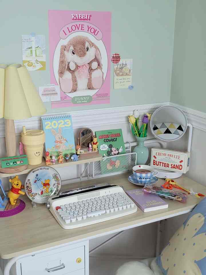 Cozy small study in yellow and white tones featuring a desk with cute character decor and accessories